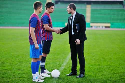 A Georgia Athlete Agent shakes hands with soccer players